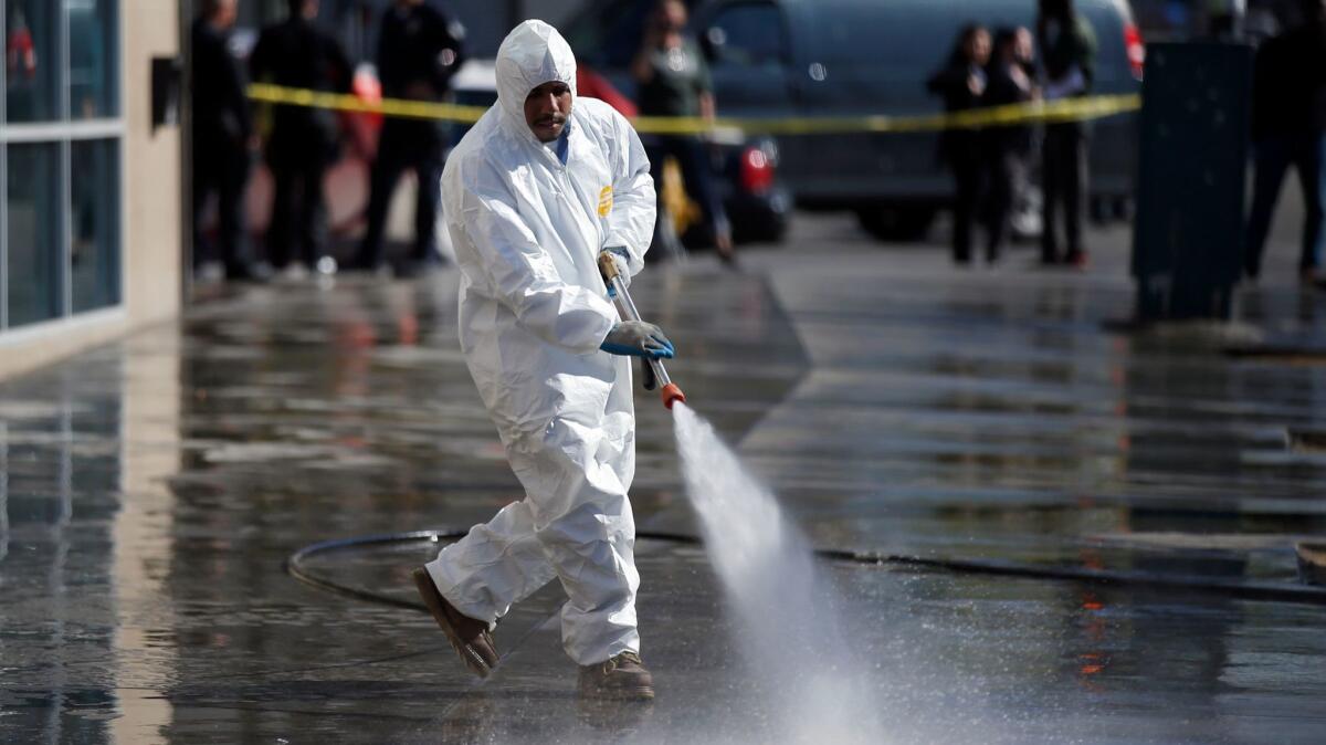 A city sanitation worker power washes the sidewalks and gutters along San Pedro Street between 5th and 7th streets, part of a skid row cleanup in 2016.