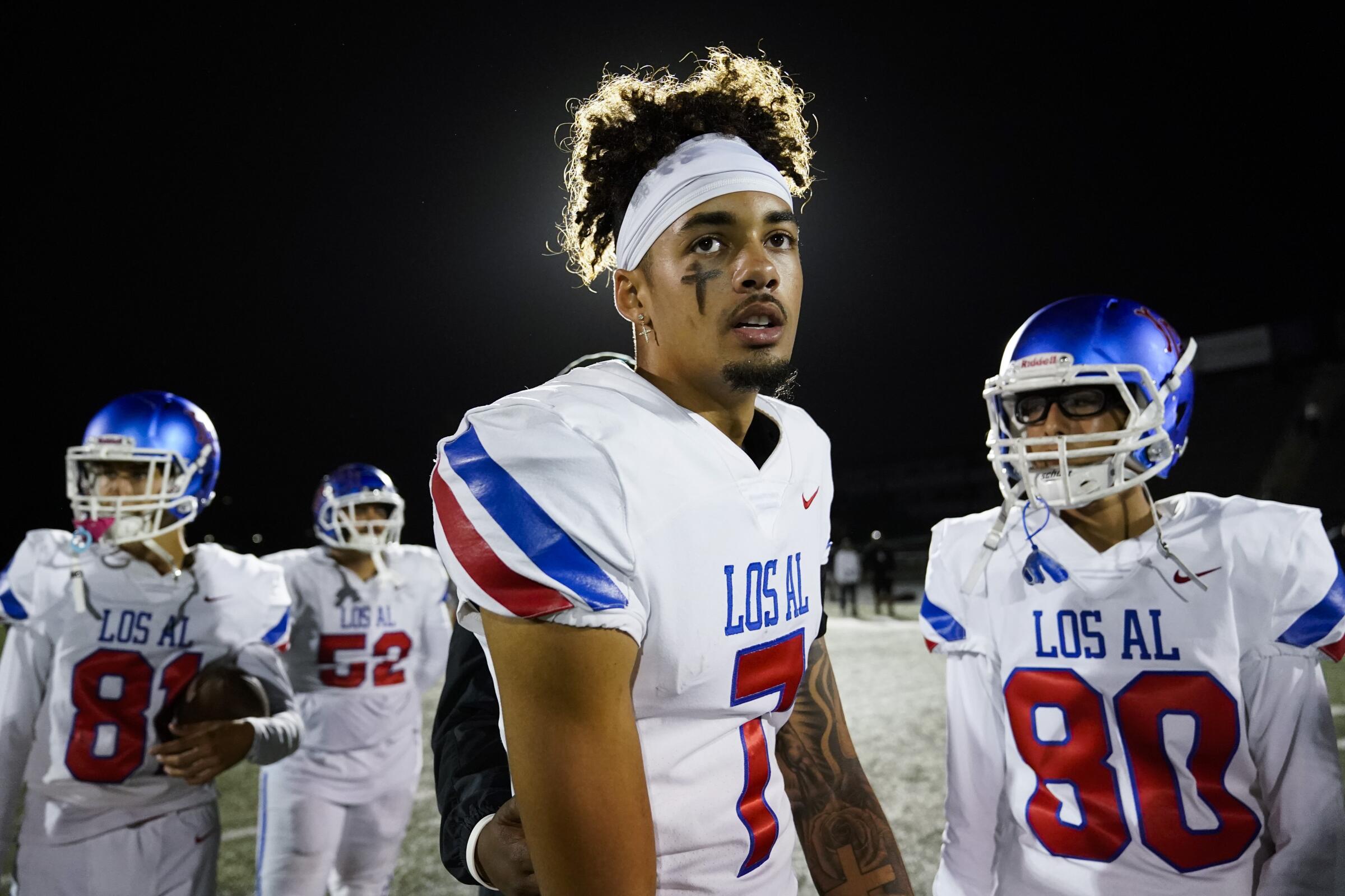 Los Alamitos High School quarterback Malachi Nelson stands on the field after a high school football game