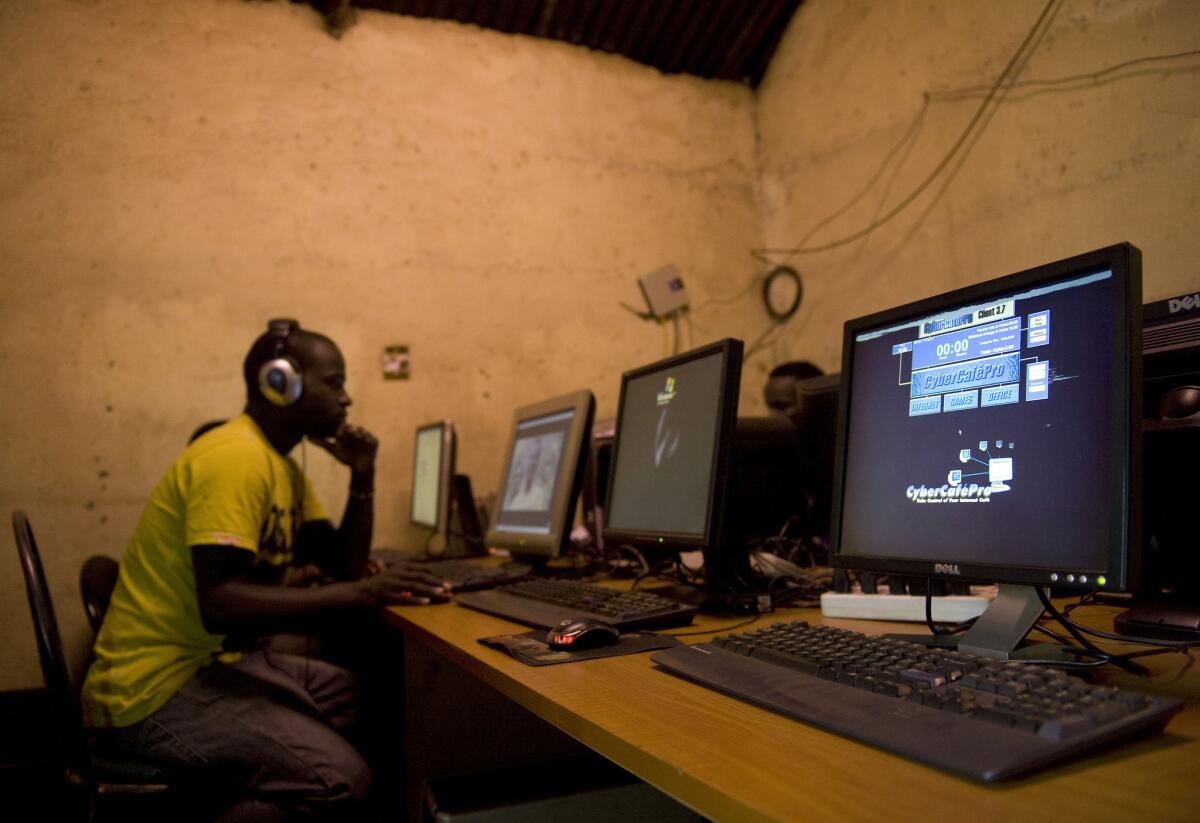 A young man sits at a cyber cafe as he surfs the Internet in Nairobi, Kenya in 2012.
