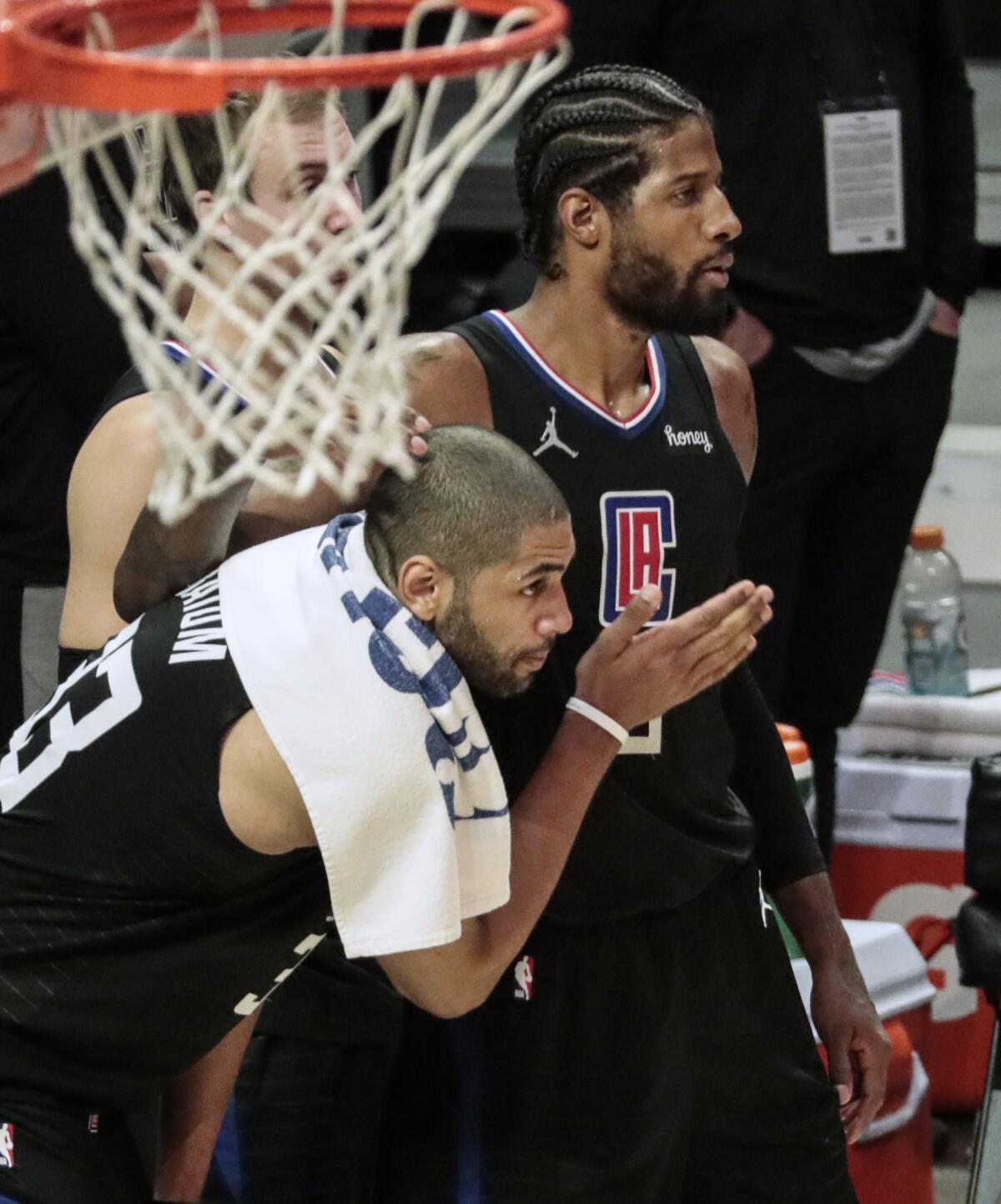 Clippers forwards Nicholas Batum and Paul George embrace on the sideline during the final seconds of a Game 4 win over Utah.