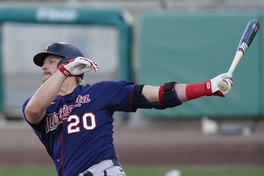 Minnesota Twins' Josh Donaldson follows through on a two-run home run in the second inning of a spring training baseball game against the Boston Red Sox, Thursday, March 25, 2021, in Fort Myers, Fla. (AP Photo/John Bazemore)