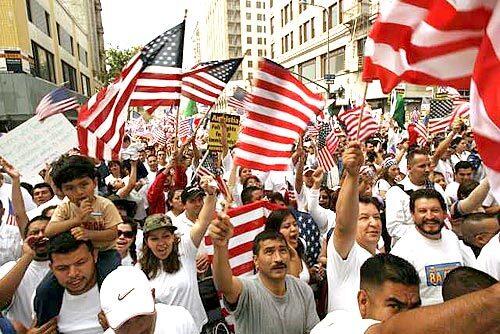 Immigrants and their supporters gather at Olympic Blvd. and Broadway Ave. in downtown Los Angeles on May 1 as part of a protest of U.S. immigration policy.