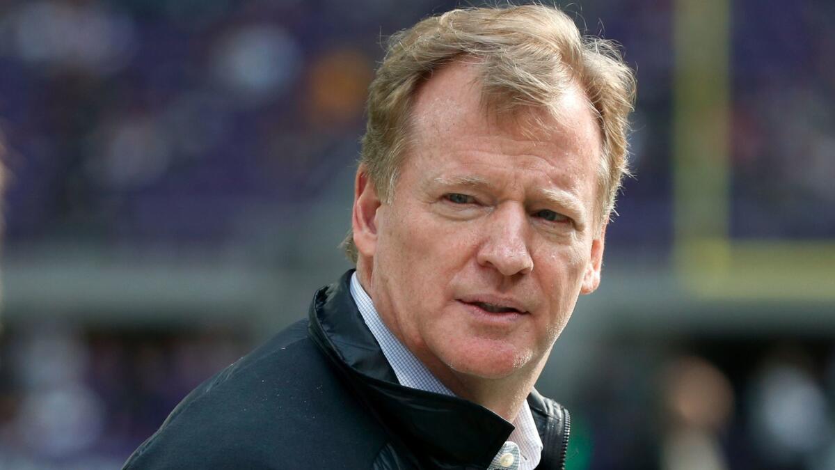 NFL commissioner Roger Goodell walks along the sideline before an NFL game between the Minnesota Vikings and Green Bay Packers in Minneapolis on Oct. 15.