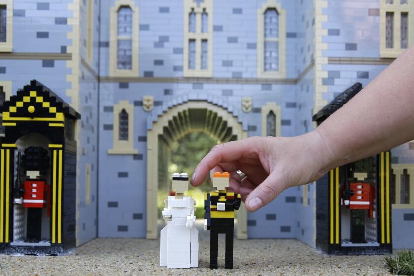 The newest attraction at Legoland in Windsor, England, Friday, May 11, 2018 shows a depiction of the upcoming wedding of Prince Harry and Meghan Markle outside Windsor Castle. All roads seem to lead to Windsor Castle, a magnificent fortress perched high on a hill topped by the royal standard when the queen is in residence. It is here â a favoured royal playground since William the Conqueror built the first structure here in 1070 â that the royal wedding of Prince Harry and Meghan Markle will take place. (AP Photo/Alastair Grant)