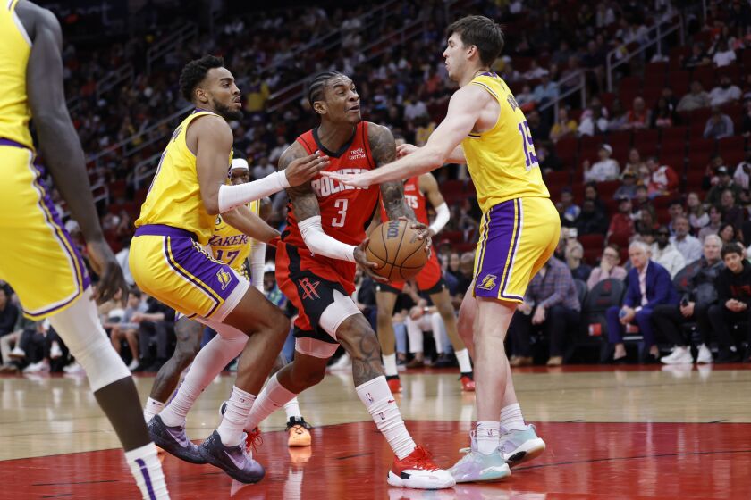 HOUSTON, TEXAS - MARCH 15: Kevin Porter Jr. #3 of the Houston Rockets drives ahead of Troy Brown Jr. #7 of the Los Angeles Lakers during the first half at Toyota Center on March 15, 2023 in Houston, Texas. NOTE TO USER: User expressly acknowledges and agrees that, by downloading and or using this photograph, User is consenting to the terms and conditions of the Getty Images License Agreement. (Photo by Carmen Mandato/Getty Images)