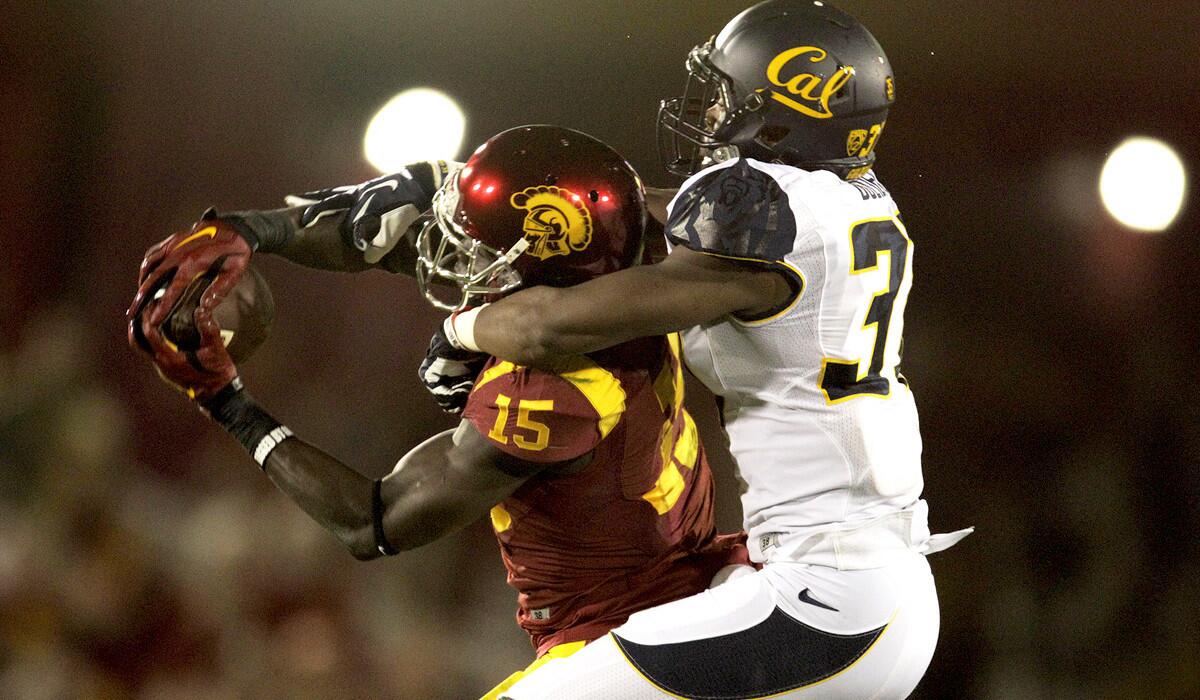 USC wide receiver Nelson Agholor catches a pass for a 34-yard gain against California cornerback Cedric Dozier in the first quarter Thursday night at the Coliseum.