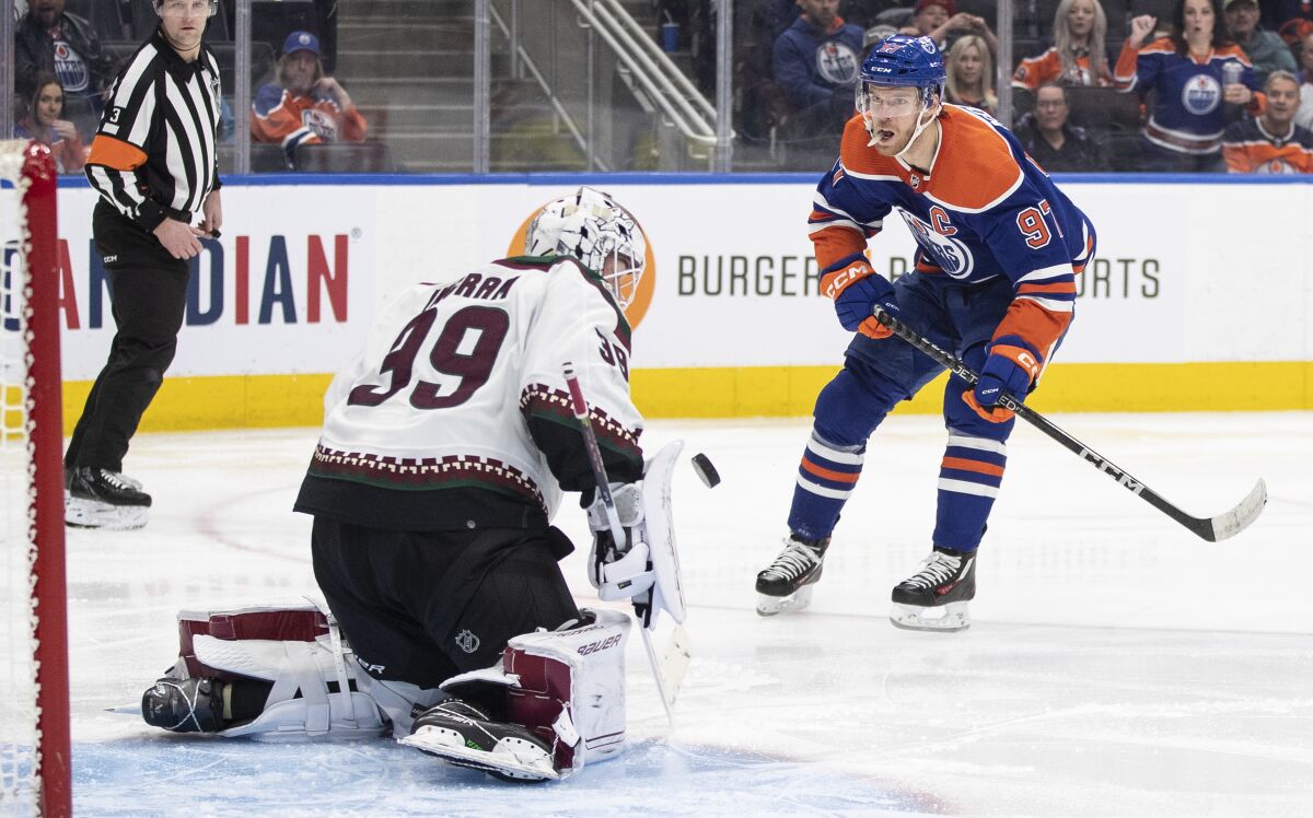 Arizona Coyotes goalie Connor Ingram (39) makes the save on Edmonton Oilers' Connor McDavid (97) during the second period of an NHL hockey game in Edmonton, Alberta, Wednesday, March 22, 2023. (Jason Franson/The Canadian Press via AP)