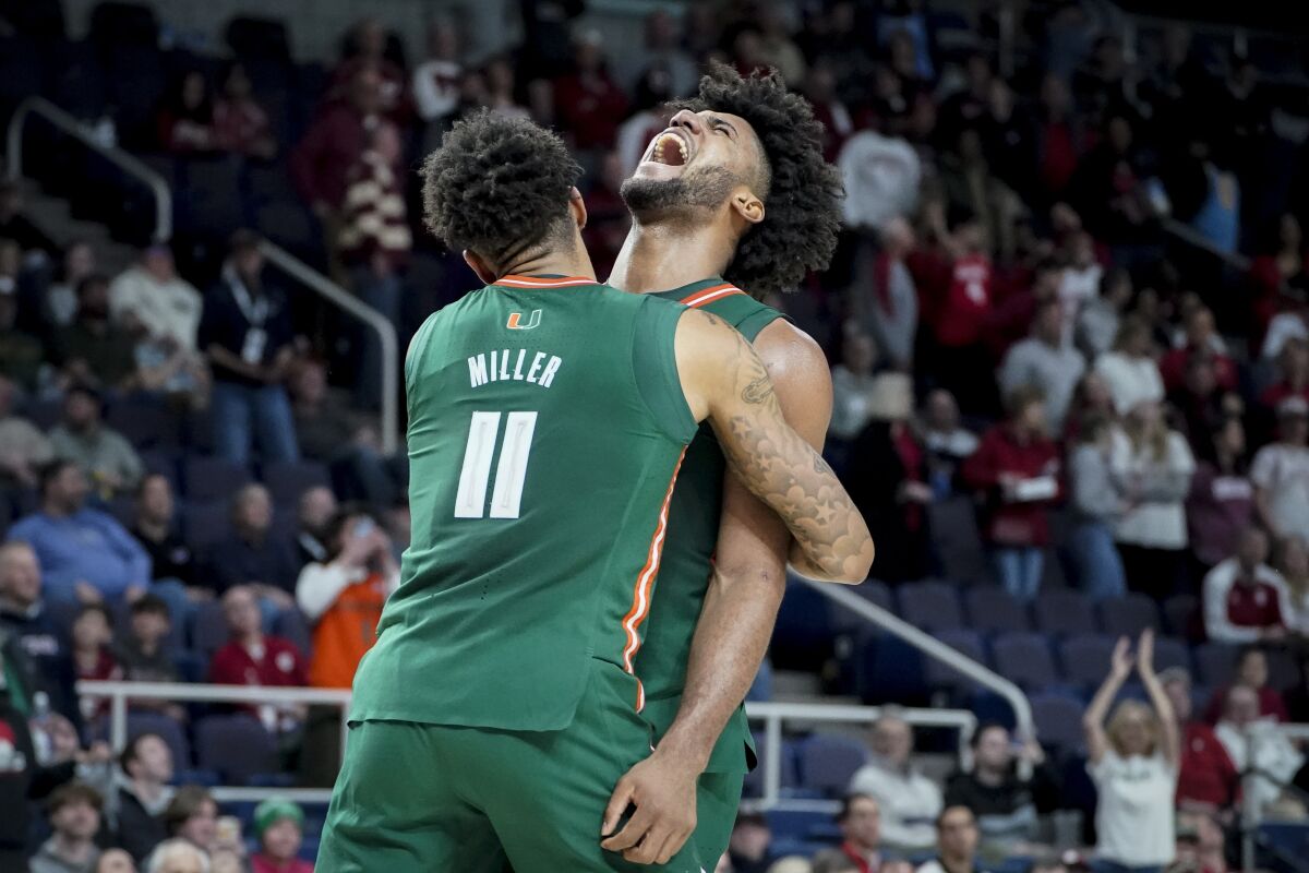 Miami's Norchad Omier, right, celebrates with Jordan Miller (11) in the second half of a second-round college basketball game against Indiana in the NCAA Tournament, Sunday, March 19, 2023, in Albany, N.Y. (AP Photo/John Minchillo)
