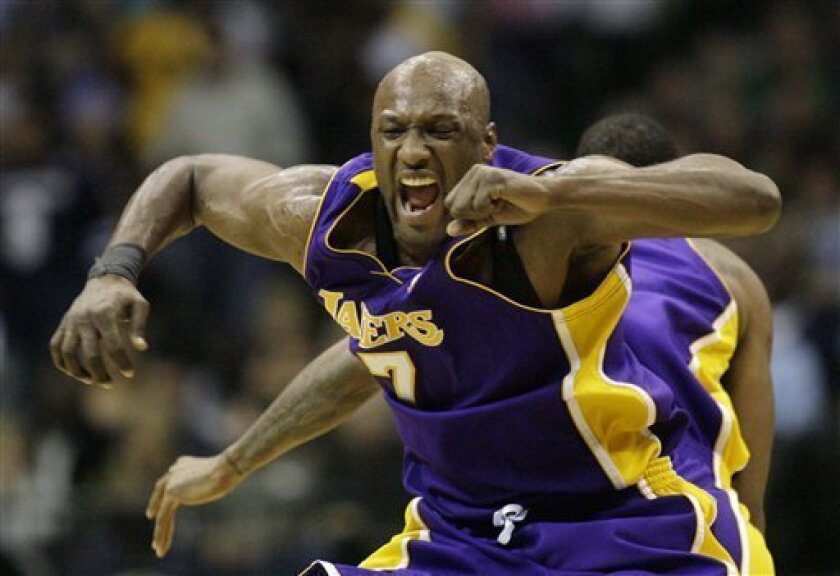 Los Angeles Lakers forwards Lamar Odom, left, and Trevor Ariza celebrate after Ariza scored the go-ahead dunk during the second half of an NBA basketball game against the Dallas Mavericks, Tuesday, Nov. 11, 2008, in Dallas. Los Angeles won 106-99. (AP Photo/Matt Slocum)