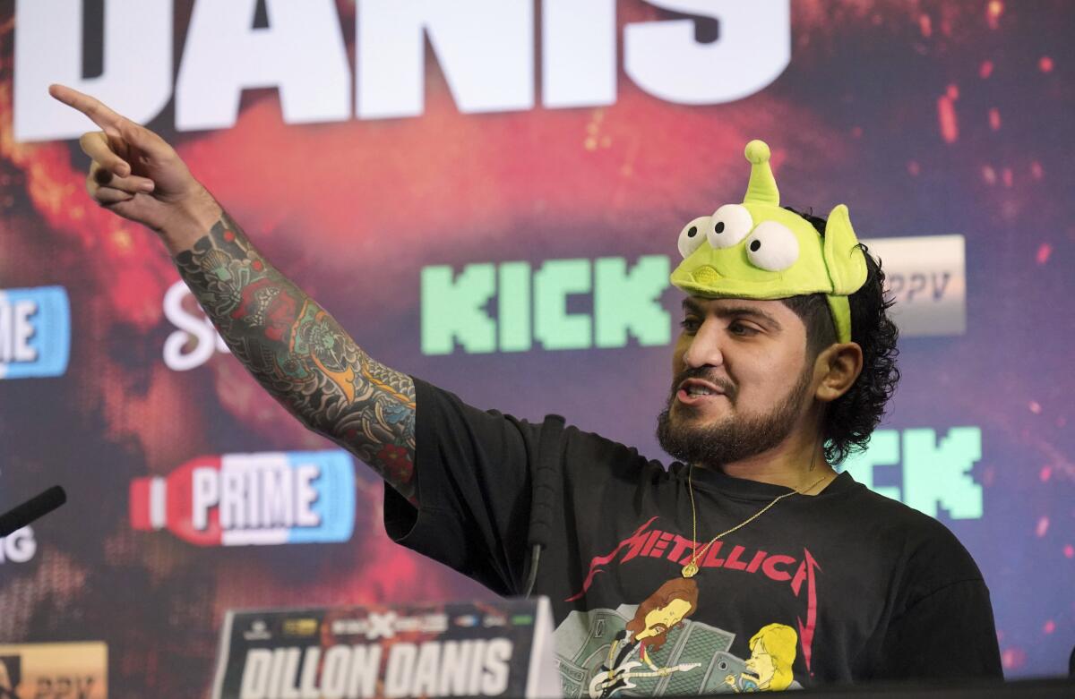 Dillon Danis is pointing during a press conference at the OVO Arena in Wembley, London.