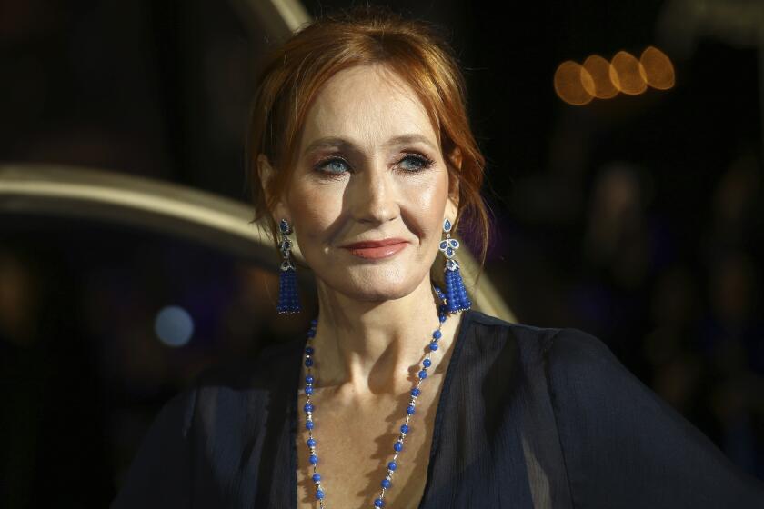 FILE - J.K. Rowling poses for photographers upon her arrival at the premiere of the film 'Fantastic Beasts: The Crimes of Grindelwald', in London, Nov. 13, 2018. Police say J.K. Rowling didn't break the law with tweets criticizing Scotland’s new hate speech law and referring to transgender women as men. (Photo by Joel C Ryan/Invision/AP, File)