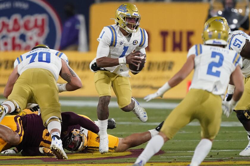 UCLA quarterback Dorian Thompson-Robinson (1) scrambles during the first half of the team's NCAA college football game against Arizona State, Saturday, Dec. 5, 2020, in Tempe, Ariz. (AP Photo/Matt York)