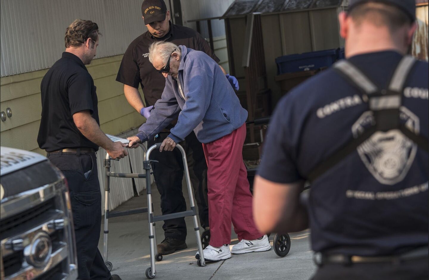 Contra Costa paramedics help Bill Parras, 96, evacuate his home in Calistoga.