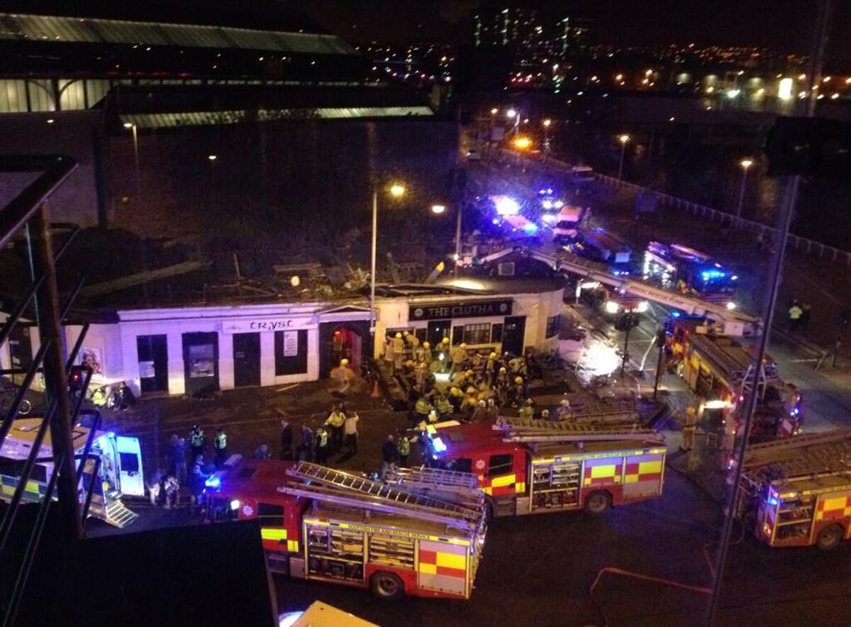 Emergency rescue crews work through the night after a police helicopter crashed through the roof of a crowded pub on the banks of the Clyde River in Glasgow, Scotland, as seen in this cellphone picture sent via Twitter by witness Jan Hollands.