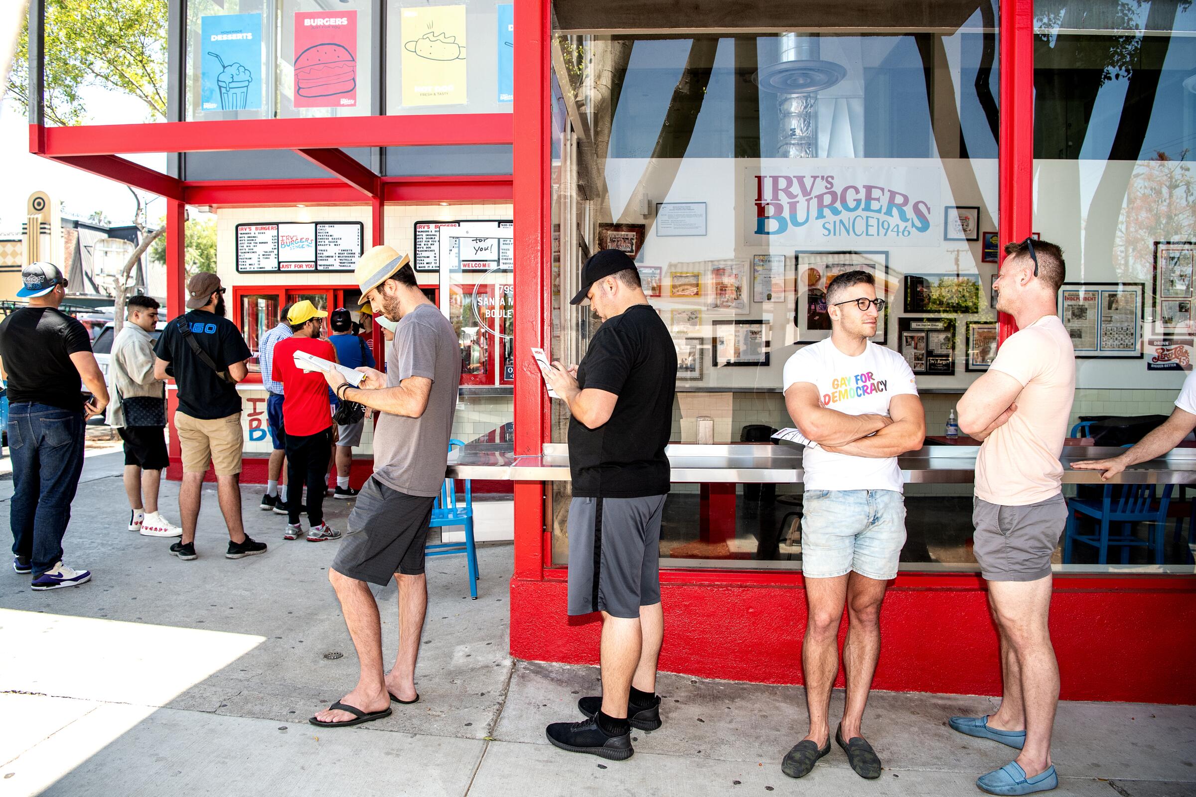 A photo of the line of customers wrapping around the restaurant's corner on reopening day of Irv's Burgers.