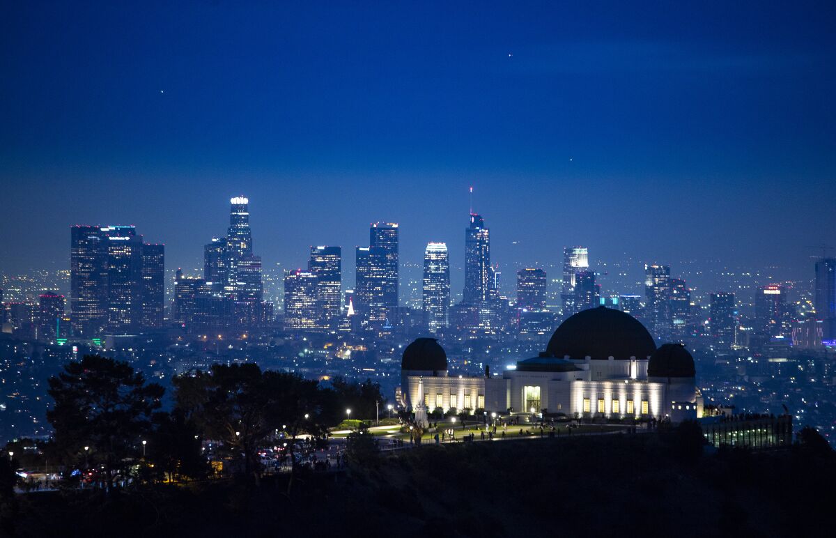 A view from Griffith Park of the Griffith Park Observatory and the downtown skyline at dusk on the last day of autumn.