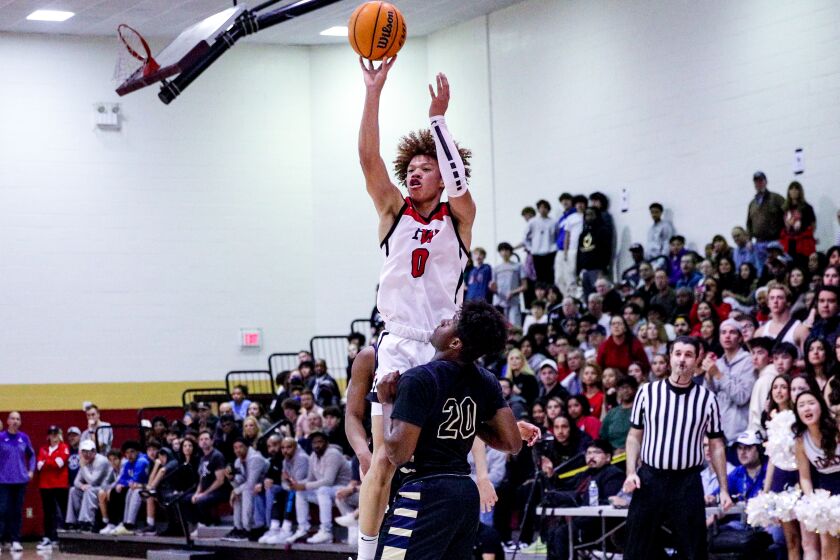 Trent Perry of Harvard-Westlake goes up against Notre Dame's Dante Ogbu in Mission League tournament championship game.