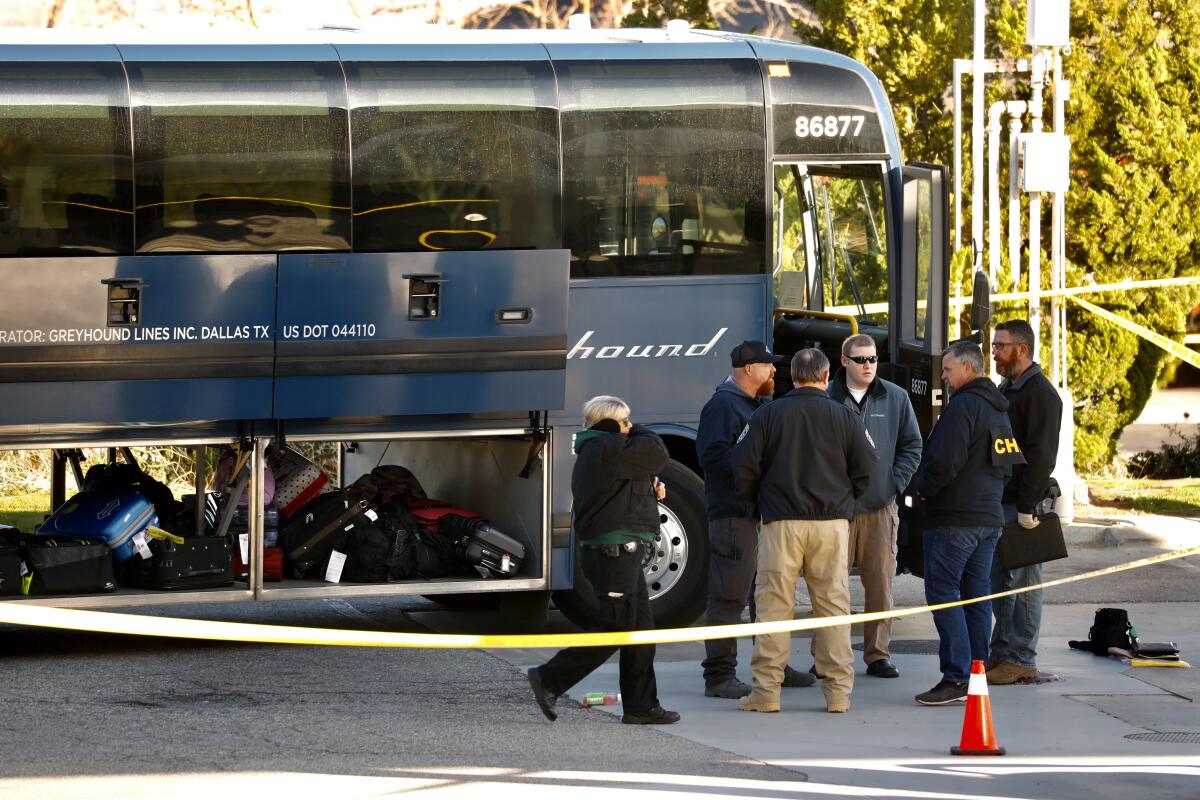 Investigators gather in Lebec, Calif., outside a Greyhound that was the scene of a fatal shooting.