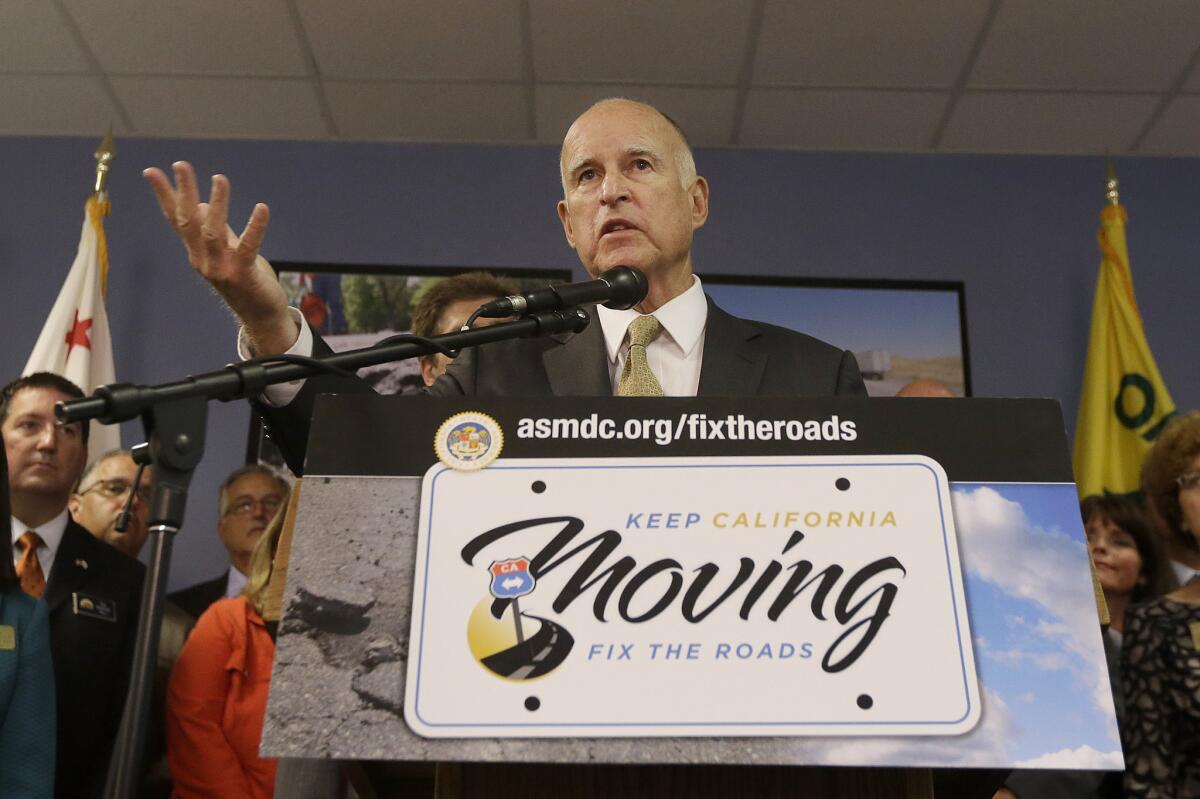 Gov. Jerry Brown speaks at an Oakland news conference about transportation last month. It's unlikely that he'll be able to forge a deal on funding repairs this week.