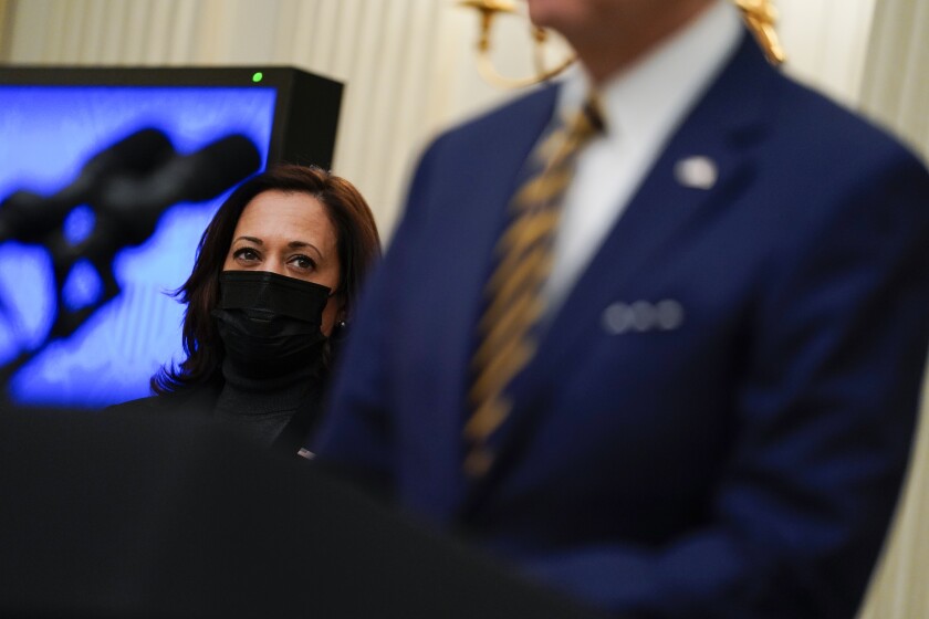 FILE - In this Jan. 22, 2021, file photo Vice President Kamala Harris listens as President Joe Biden delivers remarks on the economy in the State Dining Room of the White House in Washington. (AP Photo/Evan Vucci, File)