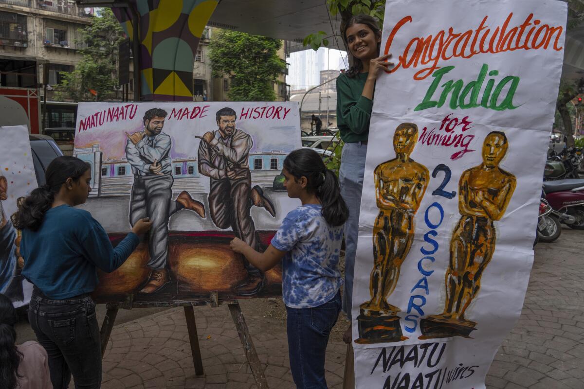 Estudiantes de una escuela de arte hacen pinturas en la calle para celebrar los dos premios Oscar de India 