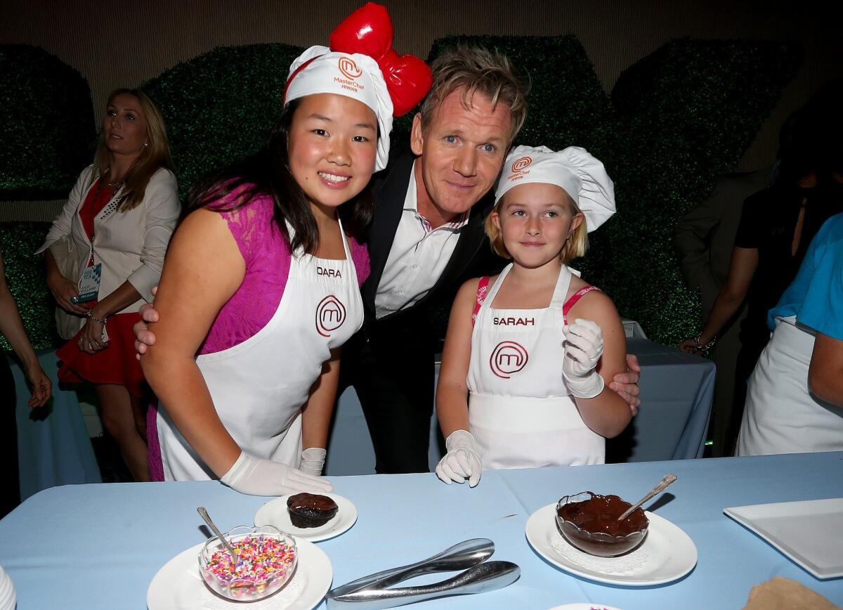 Gordon Ramsay, the executive producer of "Junior MasterChef," is joined by Dara, left, and Sarah, contestants on the show, at theTelevision Critics Assn. press tour in Beverly Hills.