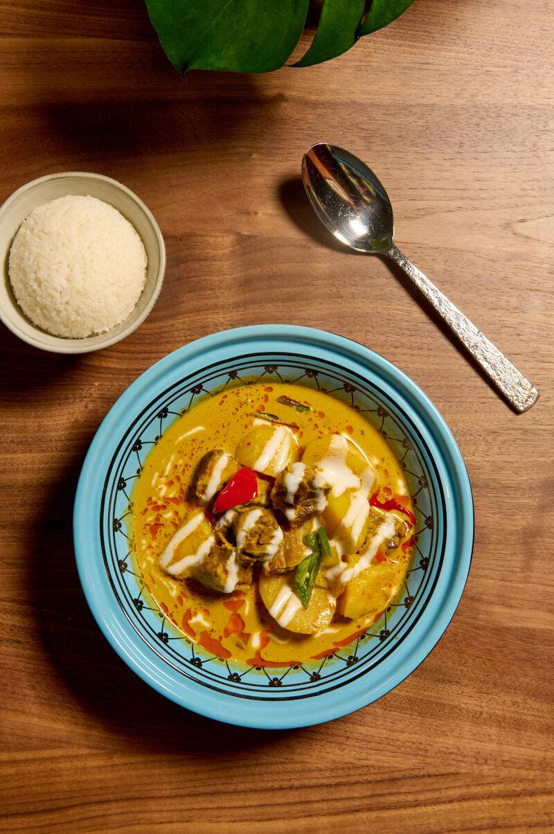 Malay Captain's curry in a turquoise bowl.