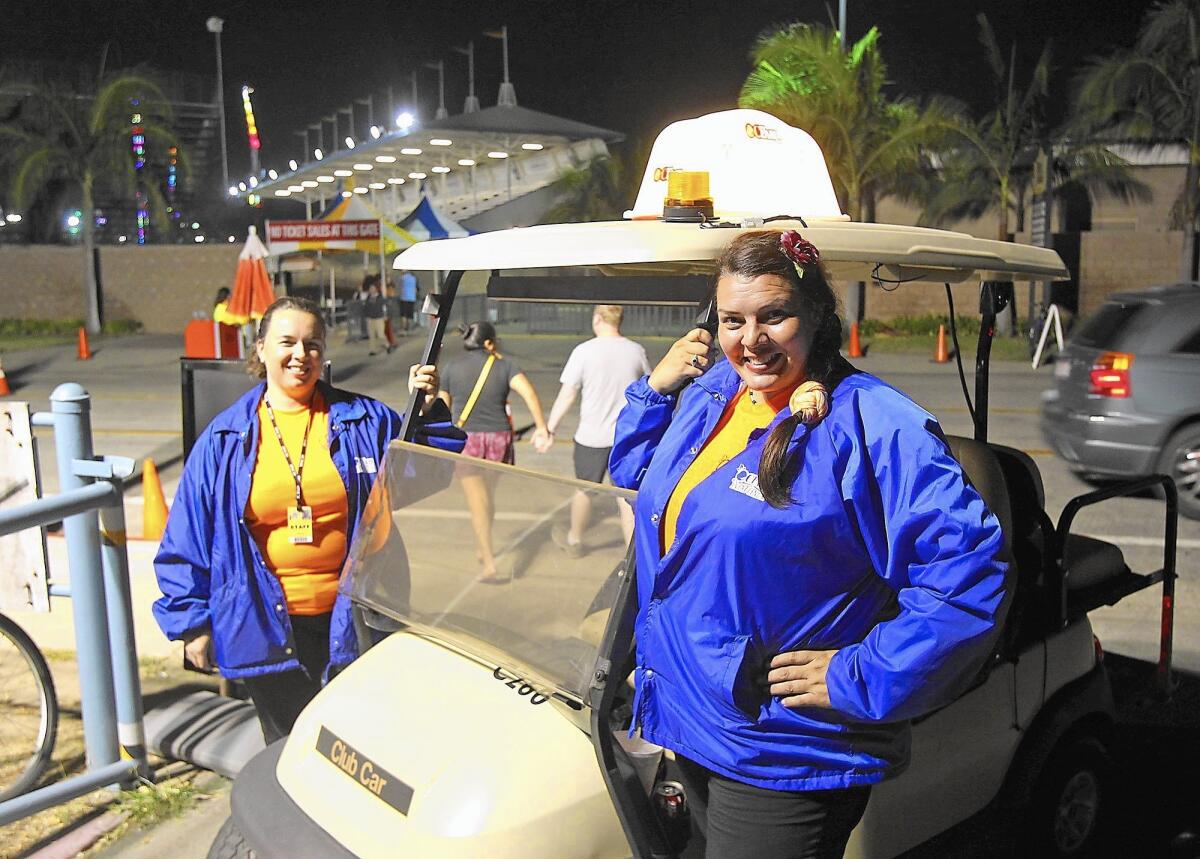 OC Fair ambassadors Janet Chompff, left, and Jenny Jones, prepare to drive the neighborhoods in their golf cart.