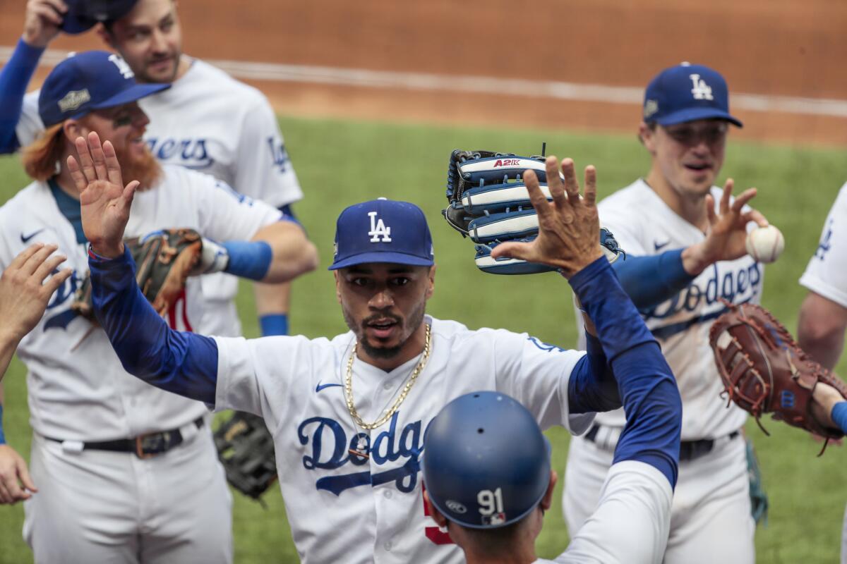 Dodgers right fielder Mookie Betts celebrates with teammates after making a leaping catch in Game 6.