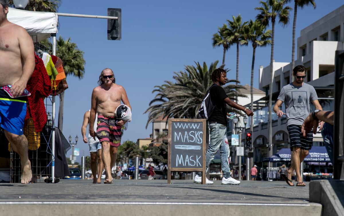 People aren't wearing masks near the pier in Huntington Beach.