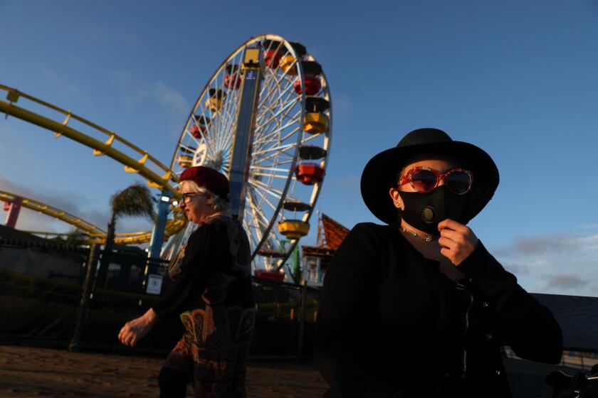 SANTA MONICA, CA - JUNE 25: Bella Nousiainen, left, with daughter, Helmi Nousiainen, of Los Angeles, at the Santa Monica Pier reopens after being closed to guests for months because of the novel coronavirus pandemic on Thursday, June 25, 2020 in Santa Monica, CA. (Gary Coronado / Los Angeles Times)