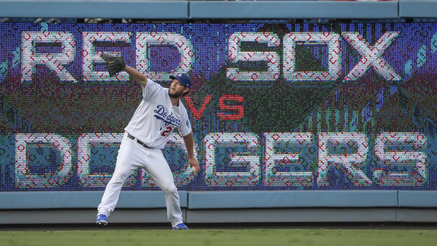 Dodgers ace Clayton Kershaw warms up in the outfield before facing the Red Sox in Game 5 of the World Series.