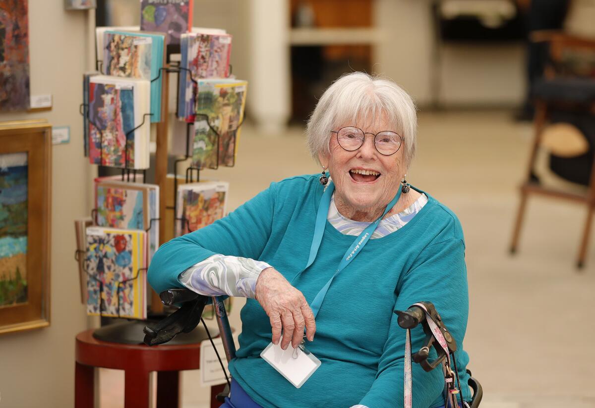 Agnes Copeland, a 90-year-old mixed media artist, welcomes guests to her booth at Art-A-Fair on June 30.