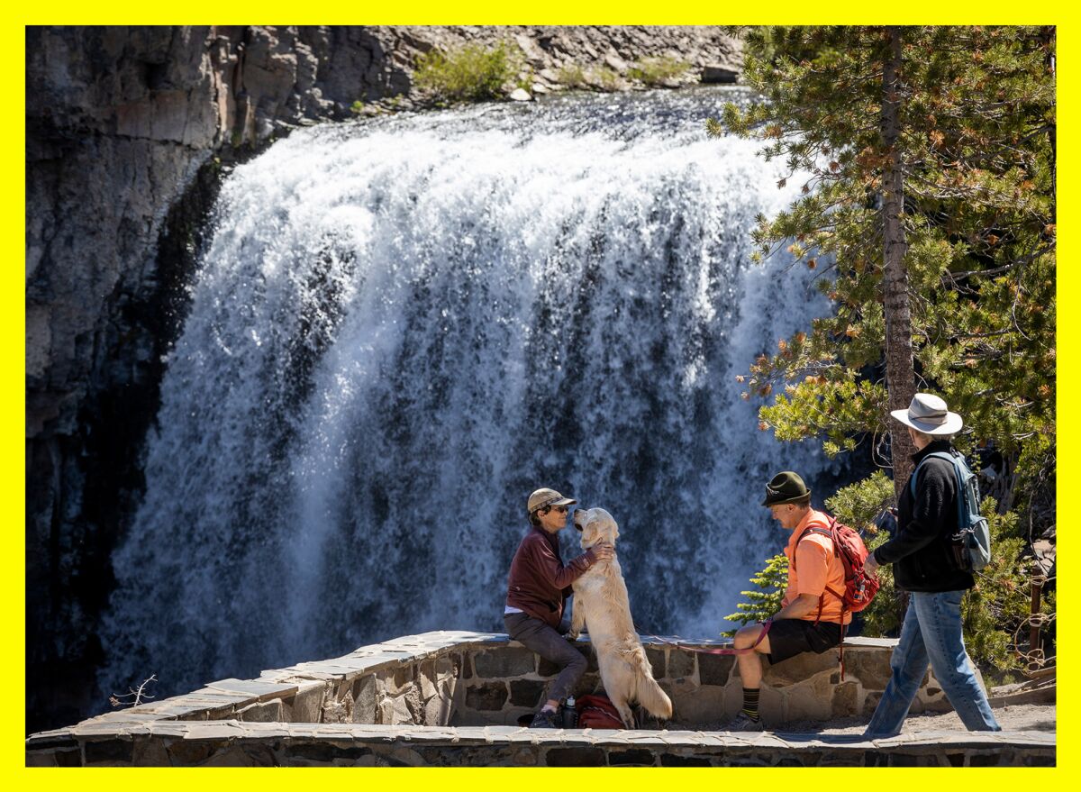 Hikers enjoy the Rainbow Falls National Monument with their dog near Red's Meadow.