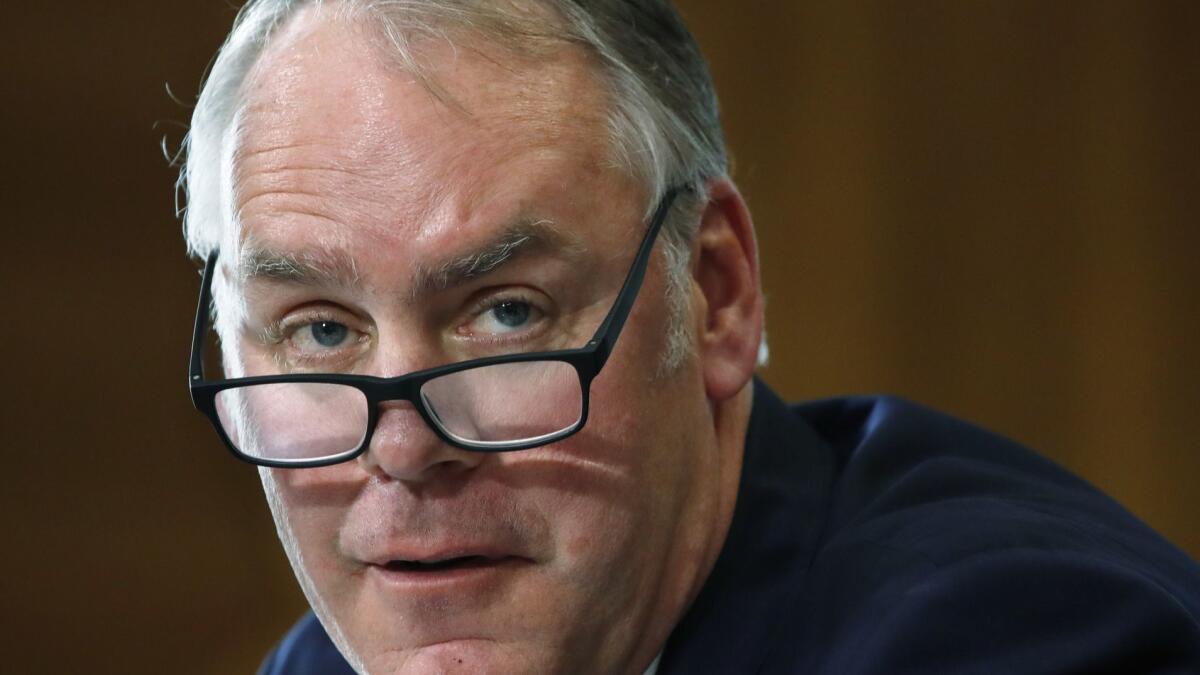 Interior Secretary Ryan Zinke, shown in a file photograph, is drawing criticism for his use of a Japanese greeting when responding to a question from a congresswoman of Japanese descent during a hearing Thursday.