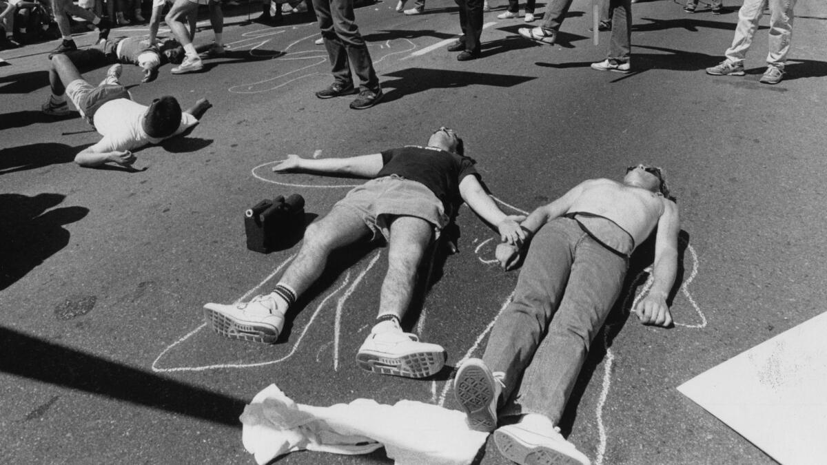 Parade participants stage a die-in at San Vicente and Santa Monica Boulevard. (Lisa Romerein / Los Angeles TImes)