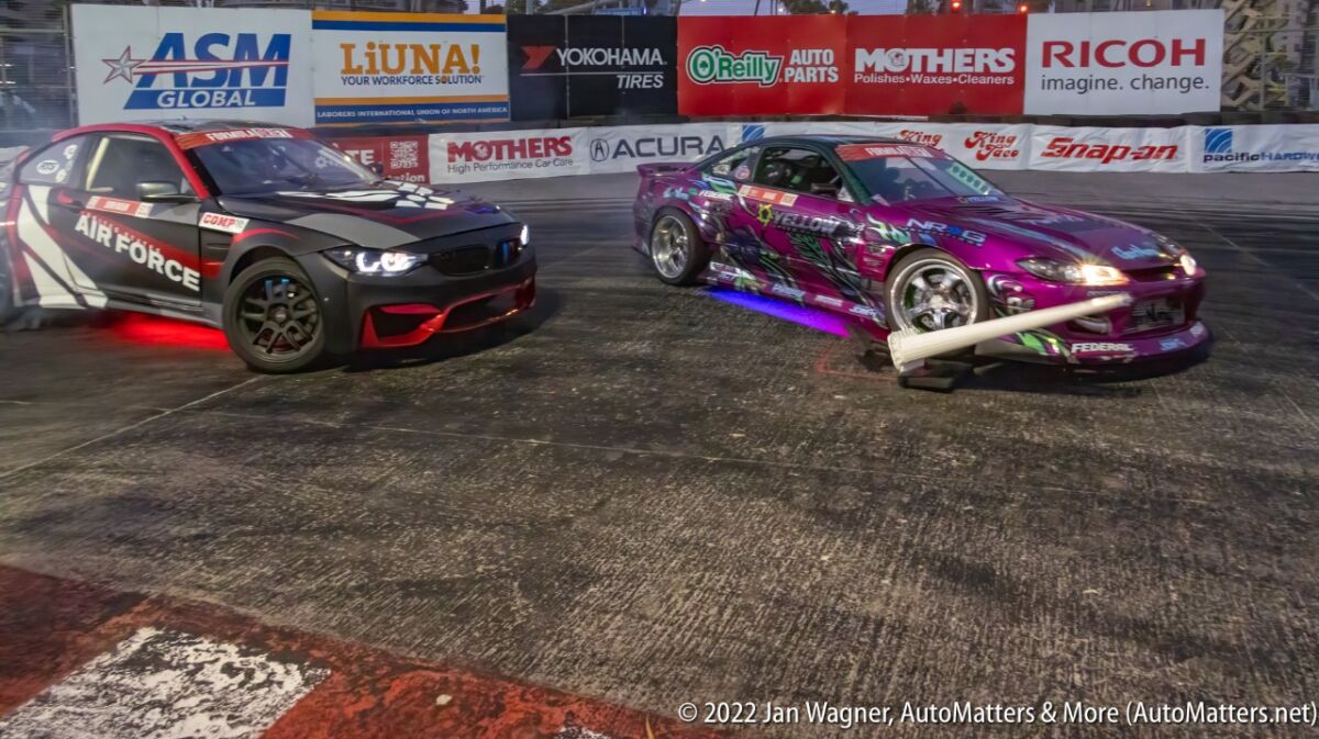 Close, side-by-side Formula D drifting through the hairpin