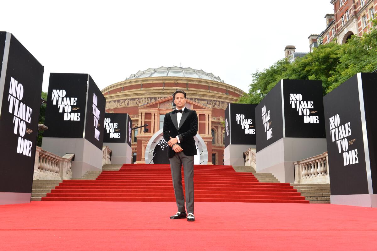 Man standing on stairs of a red carpet