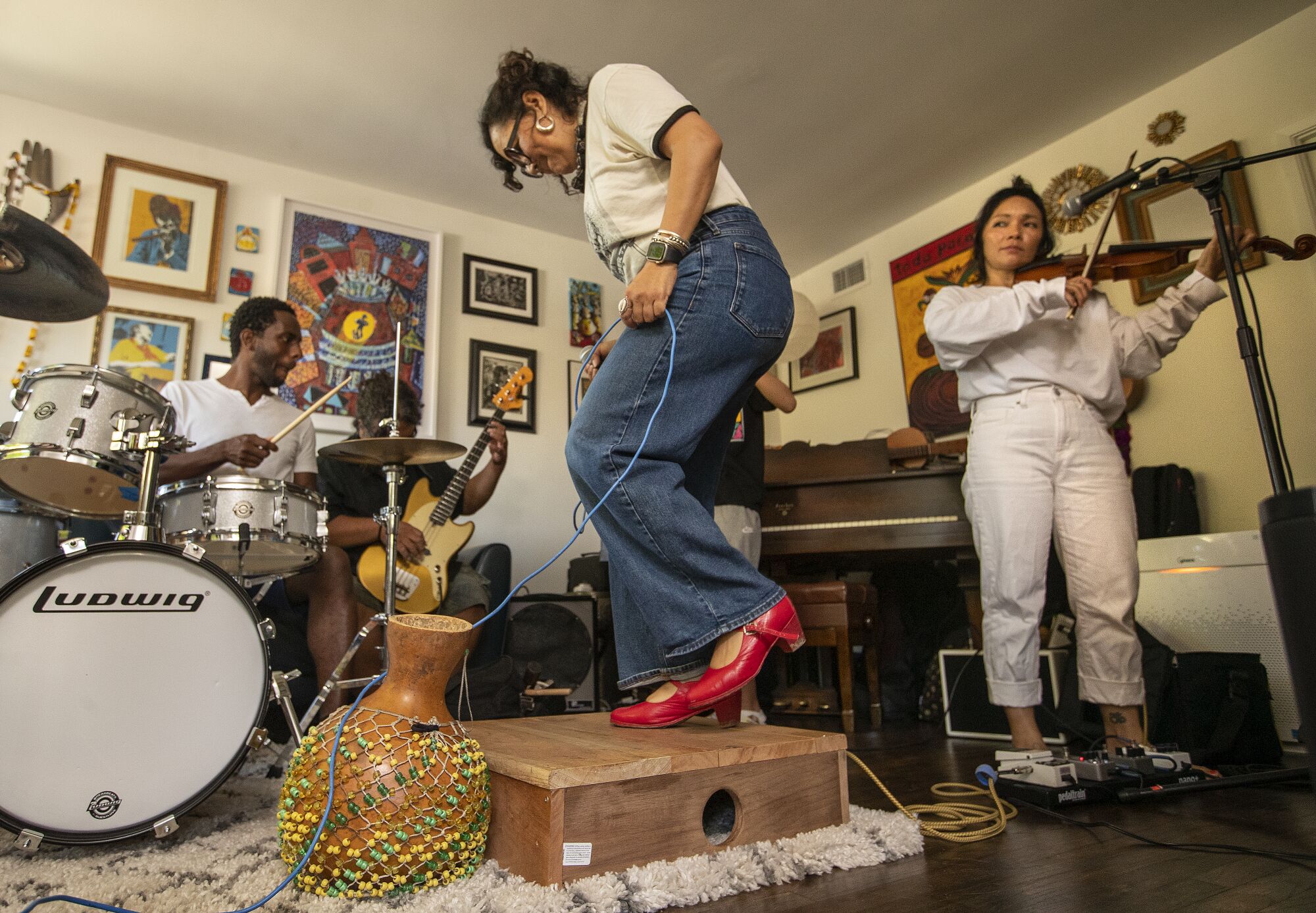  left to right- Evan Greer, Juan Perez, Dr. Martha Gonzalez and Tylana Enomoto, members of the band Quetzal, rehearse.