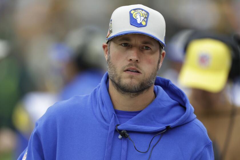 Injured Rams quarterback Matthew Stafford stands on the sideline in Green Bay.