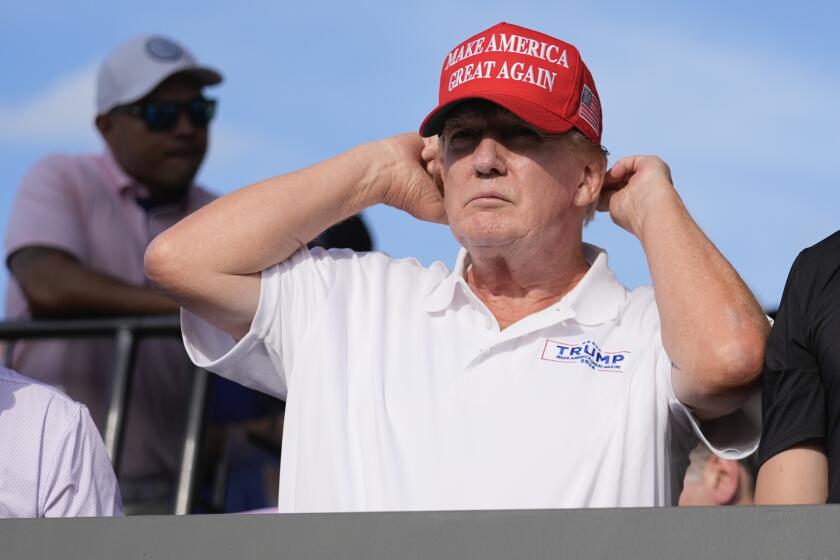 Republican presidential candidate former President Donald Trump adjusts his cap as he watches play on the 18th hole green during the final round of LIV Golf Miami, at Trump National Doral Golf Club, Sunday, April 7, 2024, in Doral, Fla. (AP Photo/Rebecca Blackwell)
