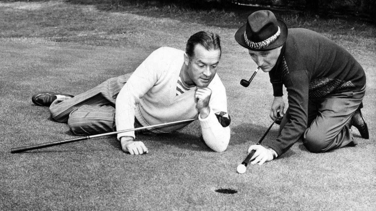 Golf holes or loopholes? Bob Hope admires Bing Crosby's technique in a promotional photo for a golf exhibition.