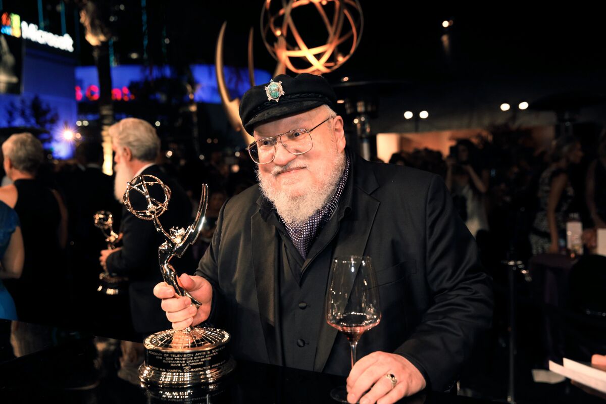 “Game of Thrones” author George R.R. Martin holding an Emmy statue.