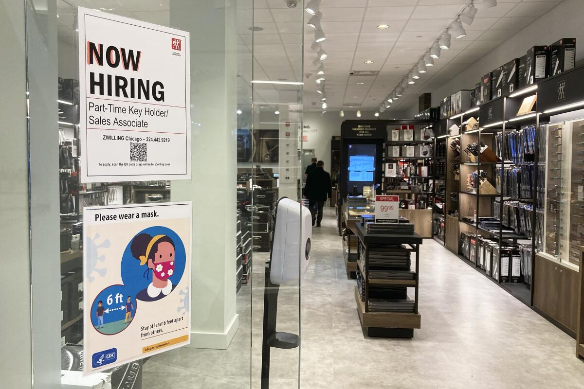 A hiring sign is displayed at a kitchen supply store in Rosemont, Ill., Tuesday, Dec. 13, 2022. The Labor Department releases weekly report on unemployment benefits on Friday, Dec. 15. (AP Photo/Nam Y. Huh)