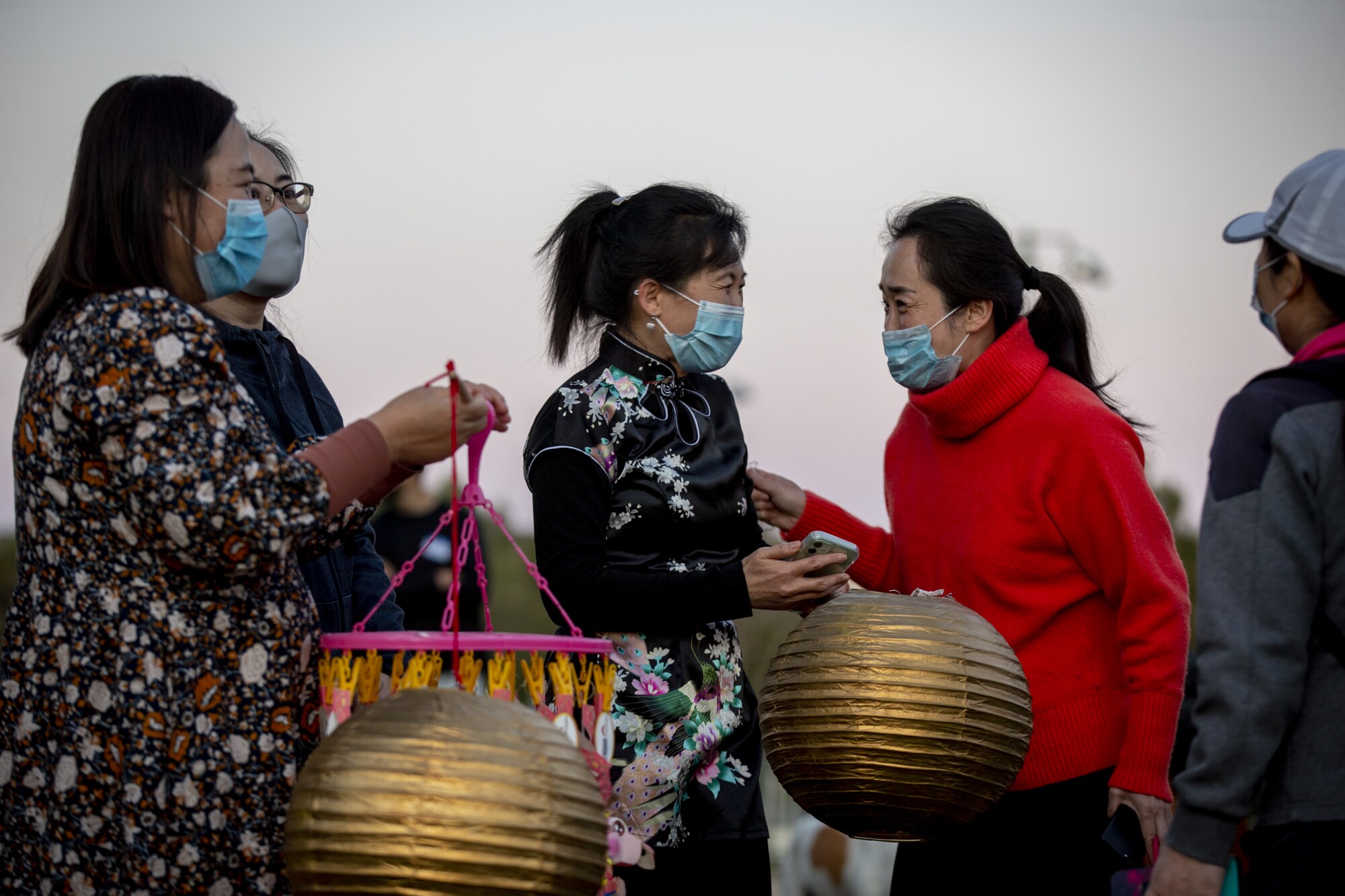 People hold lanterns during a Lantern Festival of Hope, marking the last day of Lunar New Year