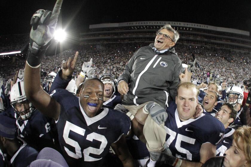 Joe Paterno is carried off the field by Penn State players after getting his 400th collegiate coaching win on Nov. 6, 2010.