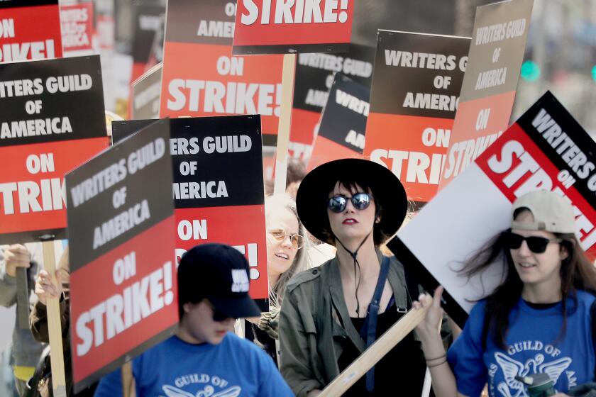 Los Angeles, CA - May 02: Striking Writers Guild of America workers picket outside the Sunset Bronson Studios on Tuesday, May 2, 2023. Los Angeles on Tuesday, May 2, 2023 in Los Angeles, CA. (Luis Sinco / Los Angeles Times)