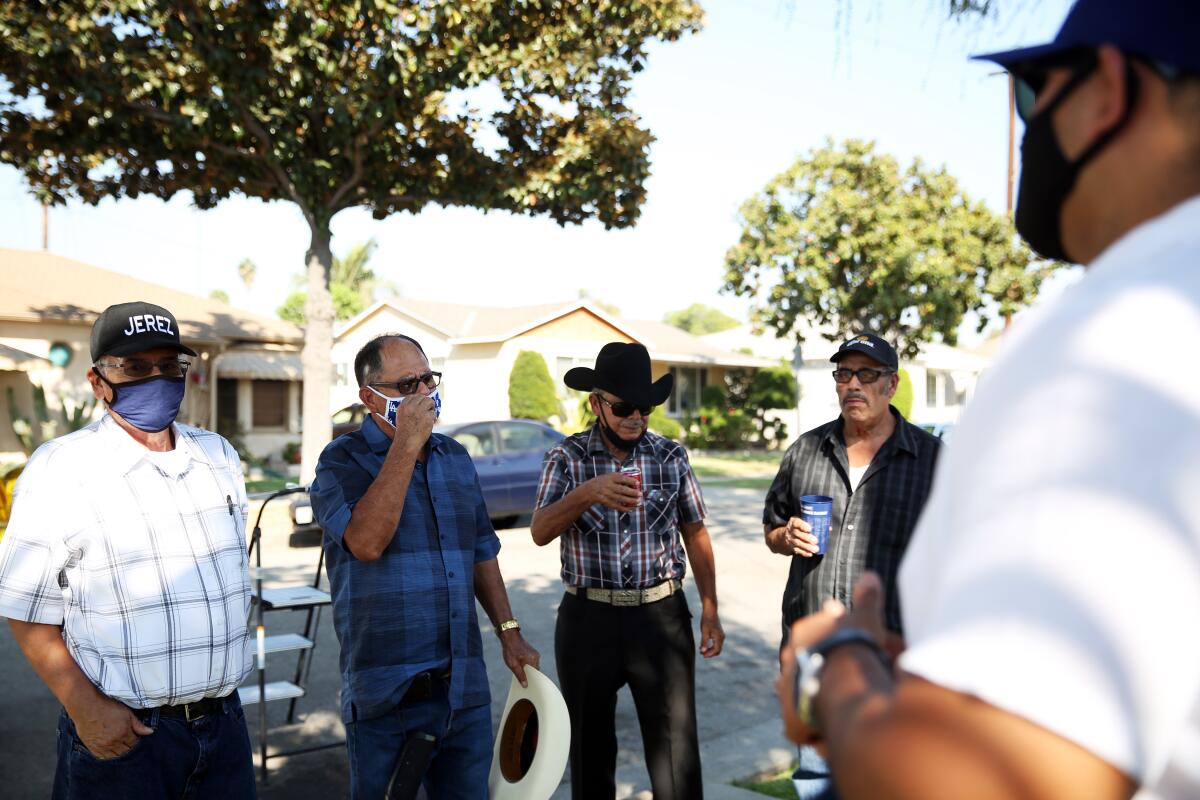 Relatives gather outside the house.