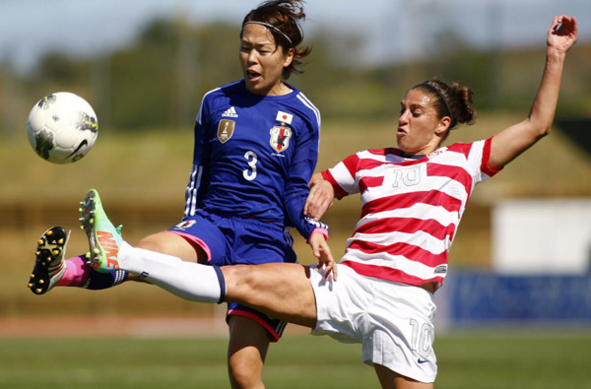 Japan defender Azusa Iwashimizu (3) and U.S. midfielder Carli Lloyd (10) vie for the ball during teir Algarve Cup game on Wednesday in Lagoa, Portugal.