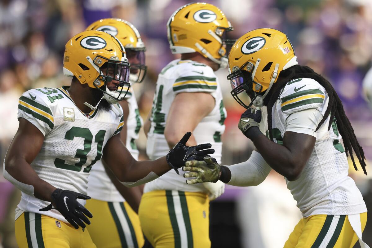 Green Bay Packers safety Adrian Amos greets inside linebacker De'Vondre Campbell.